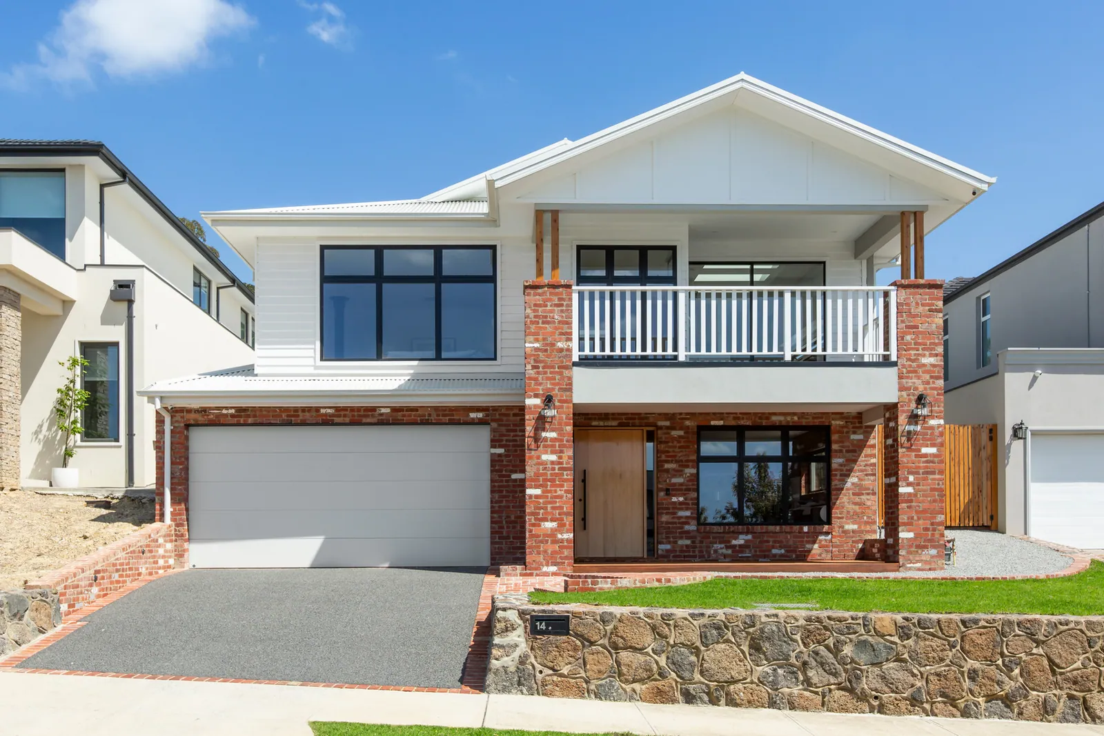 Recycled red brick base and piers on a custom home